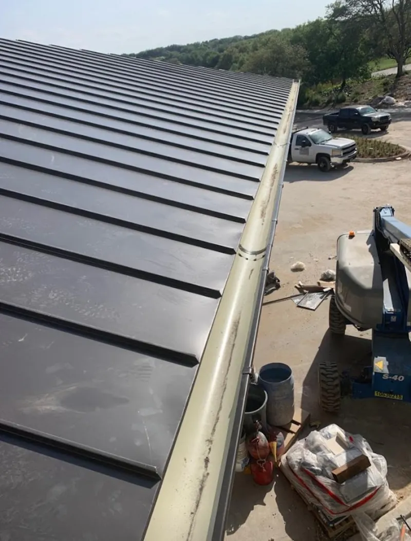 Standing seam panel and gutter detail on a metal roofing jobsite in Marietta
